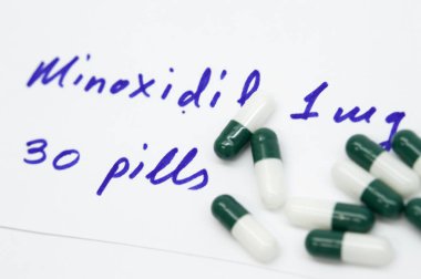 Prescription of minoxidil in pills for the treatment of alopecia clipart