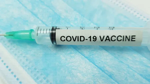 コロナウイルスワクチンでマスクと注射器を保護する — ストック写真