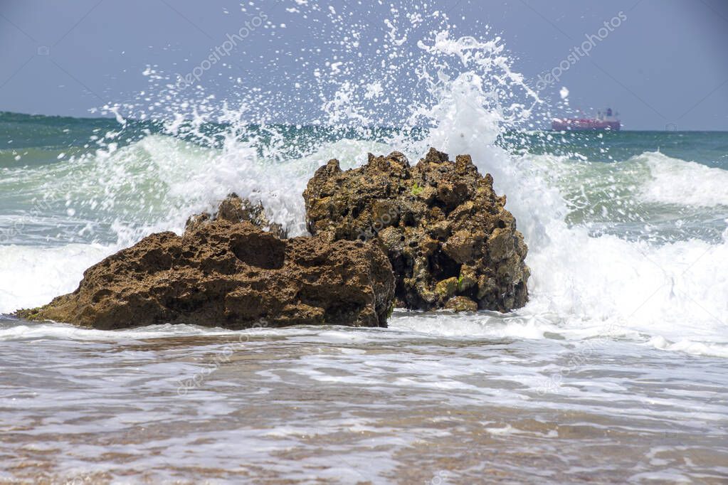 Sea waves crashing on stone formations on the shore of Ashkelon National Park