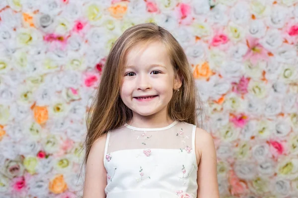 Портрет маленькой девочки на цветочном фоне — стоковое фото