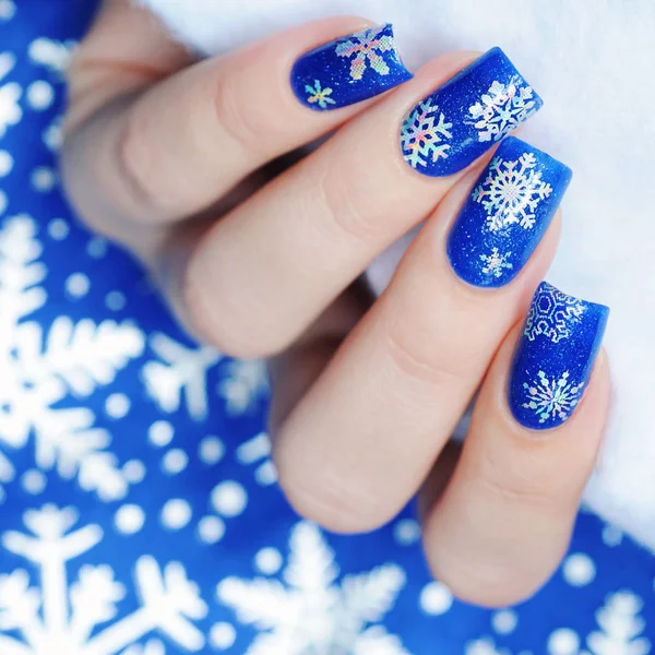Christmas winter blue manicure with a snowflakes — Stock Photo, Image