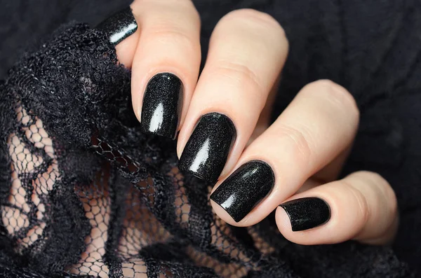 Dark blue manicure on a background of black lace — 스톡 사진