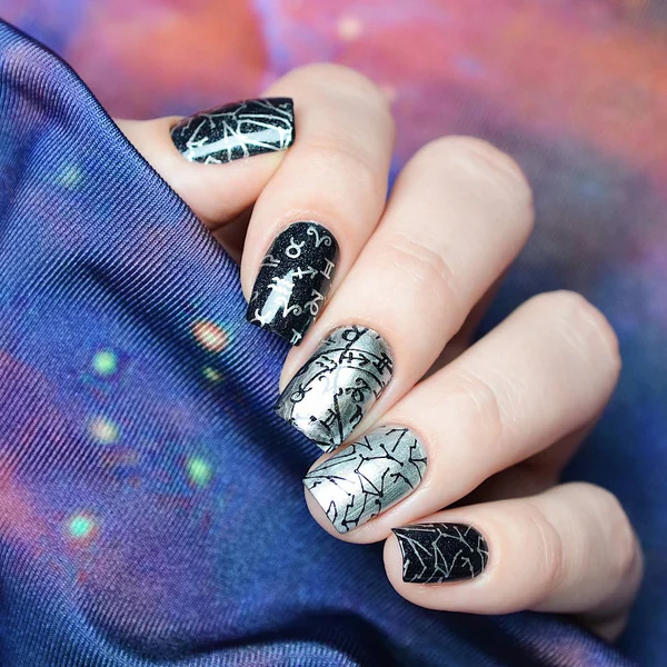 silver and black manicure with space design