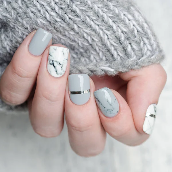 White grey marble manicure with silver stripe on grey background — Stock Photo, Image