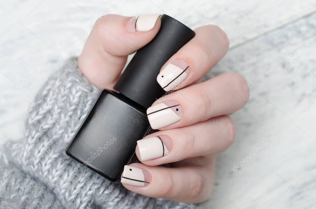 beige manicure with minimalist print with dots and lines