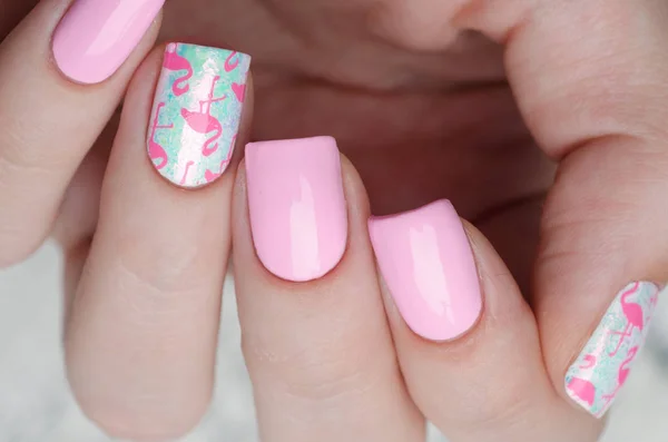 Pink manicure with pink flamingo pattern with gray sweater