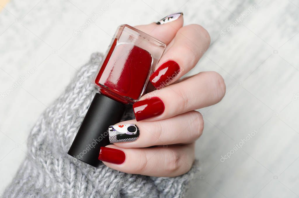 red manicure in the style of pop art with a black white woman with red lips on checkered background