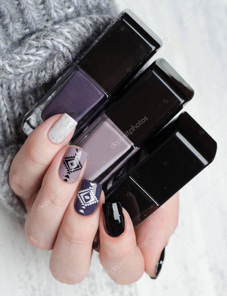 manicure in Scandinavian style in black white gray and purple color triangle pattern