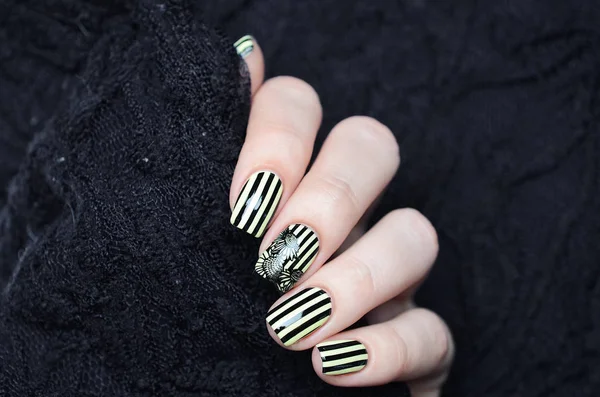 Manicura de color amarillo brillante con rayas negras y patrón de girasoles sobre fondo negro —  Fotos de Stock