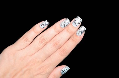 Siyah arka planda parıldayan mermer efektli gri manikür.