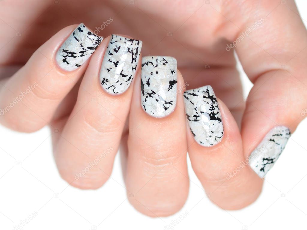 grey manicure with marblre effect with shimmer on a white background