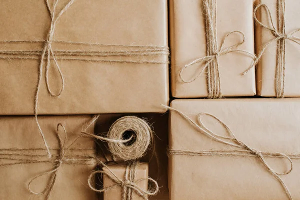 Gift box packaging. Kraft wrapping paper and natural twine. Recycling material. Happy holiday present, surprise. Gifts for boxing day. Delivery service, shipping. Handwork art craft. Celebration event