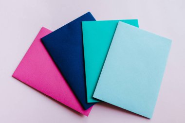 Colored paper envelopes on a light background. New mail, write message. Send and receive letter. Postal delivery service. Blank envelope, empty space. People communication, paperwork. Envelope closeup