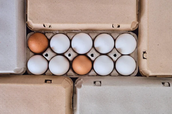 Cardboard boxes with chicken eggs. Boxes with uncooked eggs in table. Natural organic farm product. Preparing for Easter holiday. Fresh food delivery, carton package. Raw ingredient for cooking eat