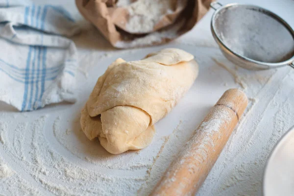 Knead dough from flour on the wooden table. Preparing the dough for baking. Cooking homemade cuisine for family. Chef workplace in kitchen. Making pastry. Healthy delicious culinary recipe