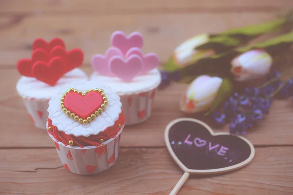 Cupcakes with small hearts . Romantic love background. Happy Valentines Day. St. Valentine\'s Day theme.