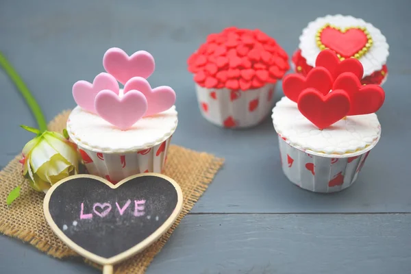 Cupcakes with small hearts . Romantic love background. Happy Valentines Day. St. Valentine\'s Day theme.