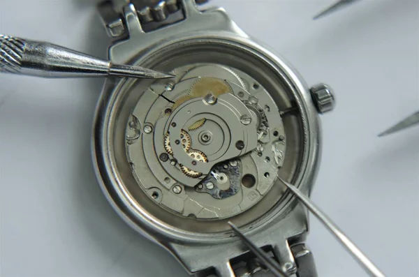 Mechanical watch and pendulum. Metal clock close-up view. Macro.