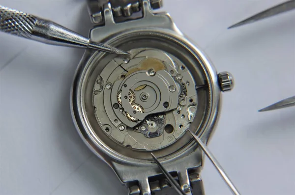 Mechanical watch and pendulum. Metal clock close-up view. Macro.