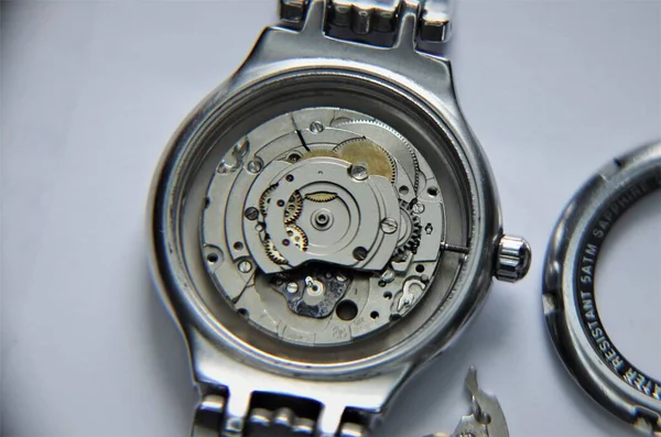Mechanical watch and pendulum. Metal clock close-up view. Macro.