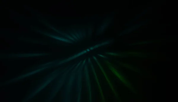 Light particles in motion, creating a burst of glowing multicolored rays on a black background. Energetic glow lights wallpaper.