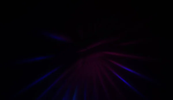 Light particles in motion, creating a burst of glowing multicolored rays on a black background. Energetic glow lights wallpaper.