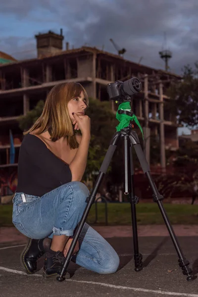 Joven hermosa mujer rubia en suéter oscuro mirando al espejo —  Fotos de Stock