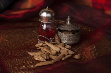 Agarwood, also called aloeswood, oil and incense chips clipart