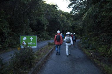 Poas Volcano National Park, Costa Rica-January 23, 2019:tourist hiking to the volcano crater. It is active and has one of the largest craters in the world. clipart