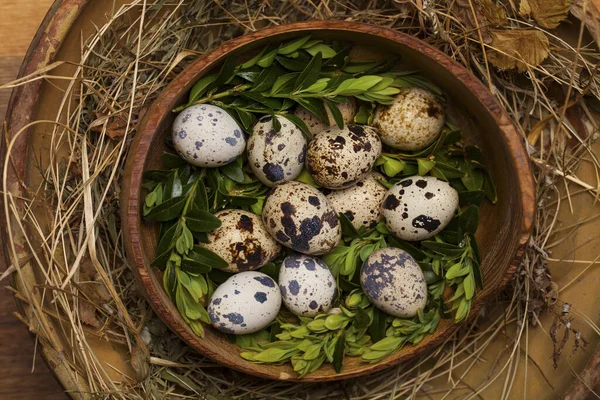 Vintage chicken,turkey and quail eggs in a wooden bowl