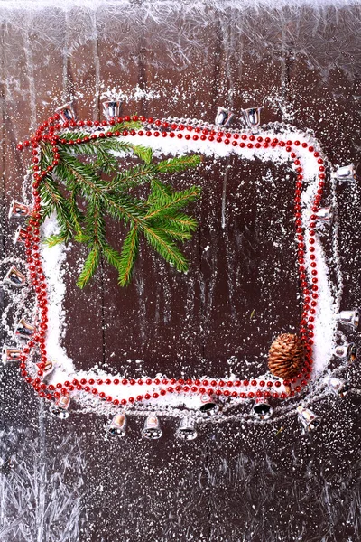 Frame of the snow with a Christmas tree and fir cones on a snowy winter dark wooden background booklet — Stock Photo, Image