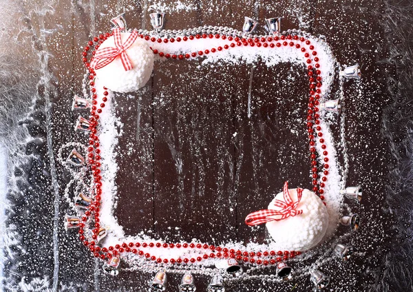 Frame of the snow with Christmas balls on a snowy winter dark wooden background booklet — Stock Photo, Image