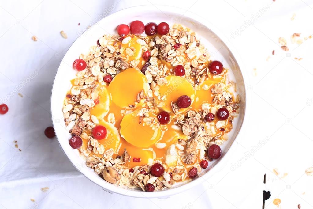 Breakfast granola with cranberries banana and mango mousse
