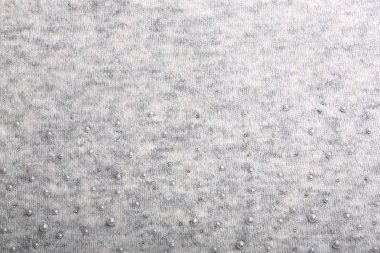 Örgü arka plan. Açık gri yumuşak yün arka plan deseni. Arkaplanda boncuklarla işlenmiş.