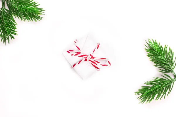 Christmas holiday composition gift box with spruce branch on a white background. minimalistic holiday concept — Stock Photo, Image