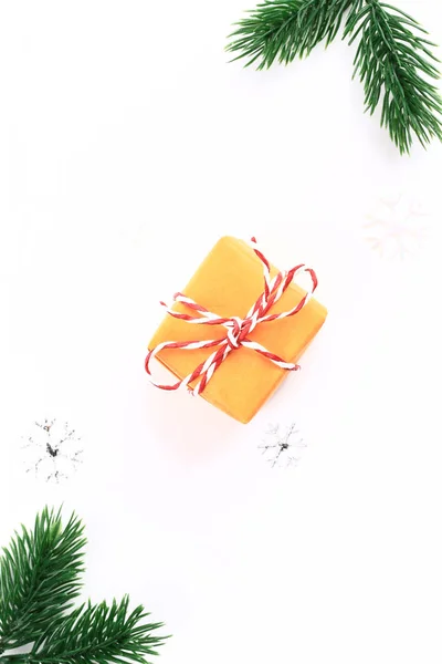 Christmas holiday composition Orange gift box with fir branches on a white background. minimalistic holiday concept — Stock Photo, Image