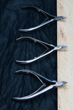 A set of cosmetic tools for manicure and pedicure stand on a bla