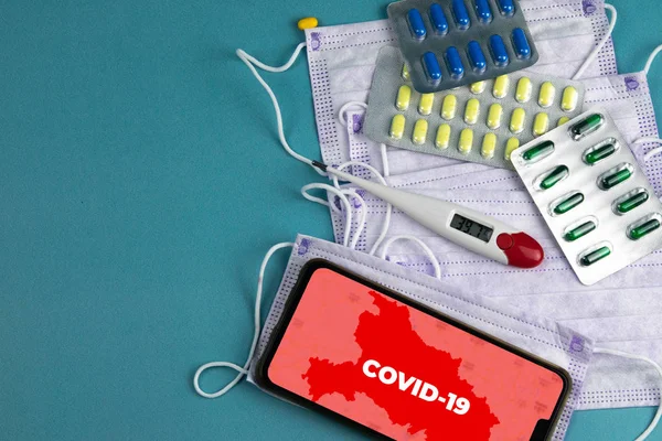 COVID 2019. Corona virus outbreaking. Epidemic virus Respiratory Syndrome. China.Blood tube, Phonendoscope, Mask, syringe, tablets and gloves With a phone that says COVID 2019