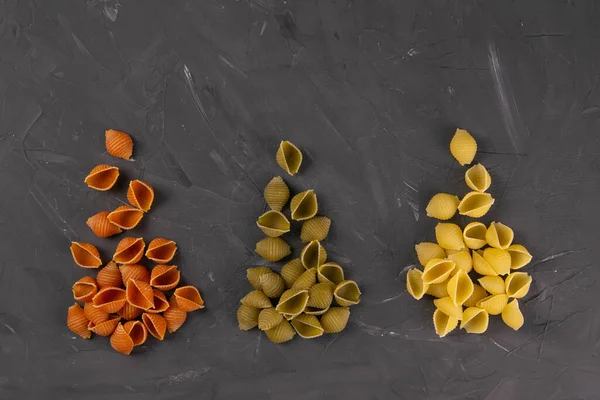 Top View Dry Conchiglie Pasta Black Board Background Three Triangular — Stock Photo, Image