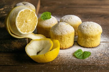 Koyu ahşap masada limonlu ve naneli kekler. Üst görünüm, yakın plan.