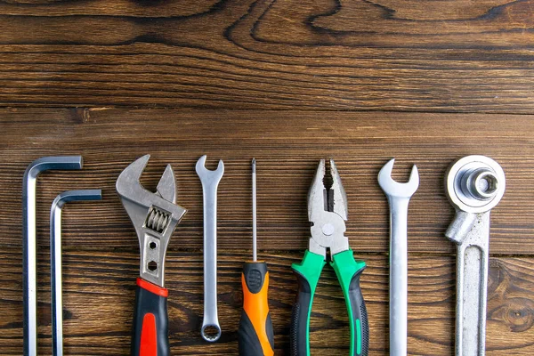 Set of tools over a wood panel with space for text. Top views with clear space.