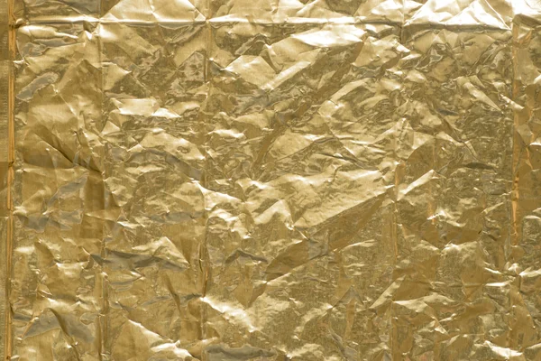 Gold creased metallic foil background texture — Stock Photo, Image