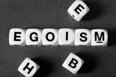word egoism on toy cubes clipart