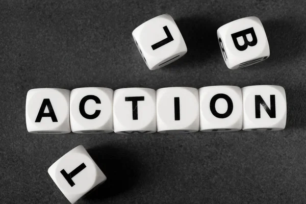 Word action on toy cubes — Stock Photo, Image