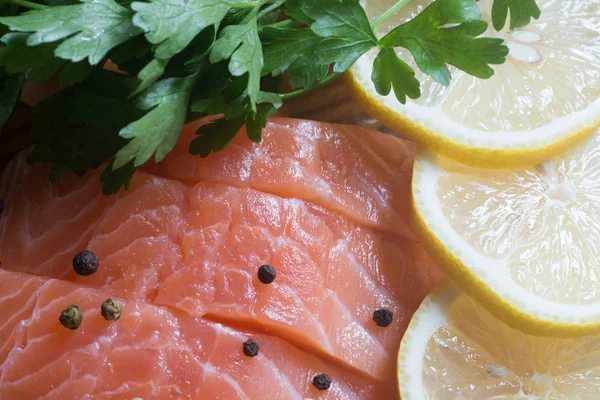 Raw salmon with parsley, pepper and lemon — Stock Photo, Image