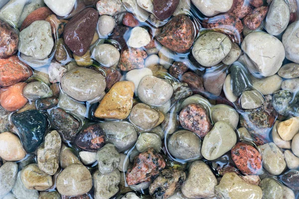 Pebble stones in water — Stock Photo, Image