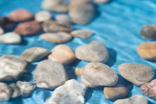 Pebble stones in water — Stock Photo, Image