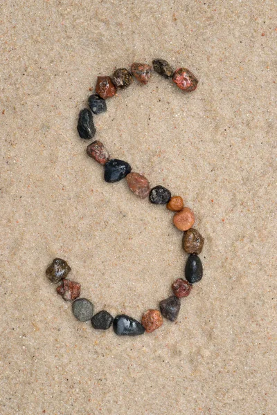 Pebble  s letter on sand — Stock Photo, Image