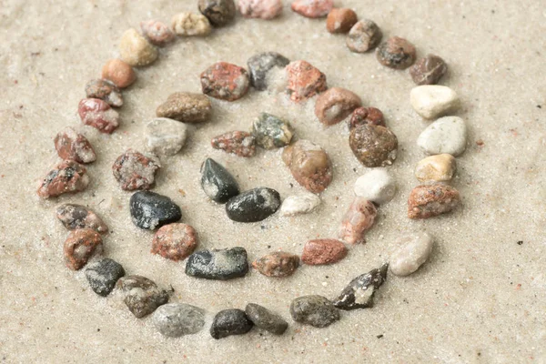 Pebble concentric circles on sand  selective focus — Stock Photo, Image