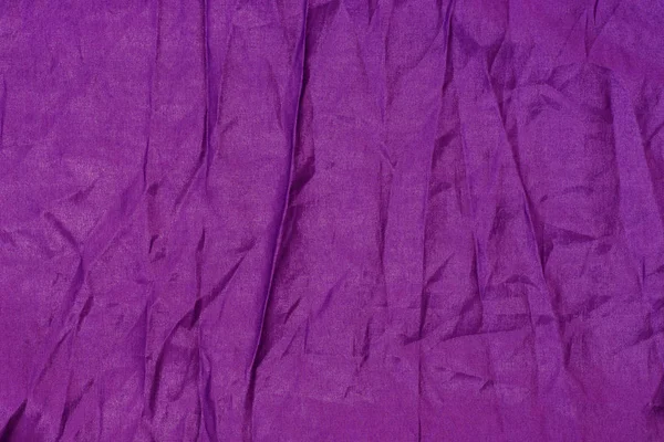 Фиолетовый шелк текстиль складки фона текстуры — стоковое фото